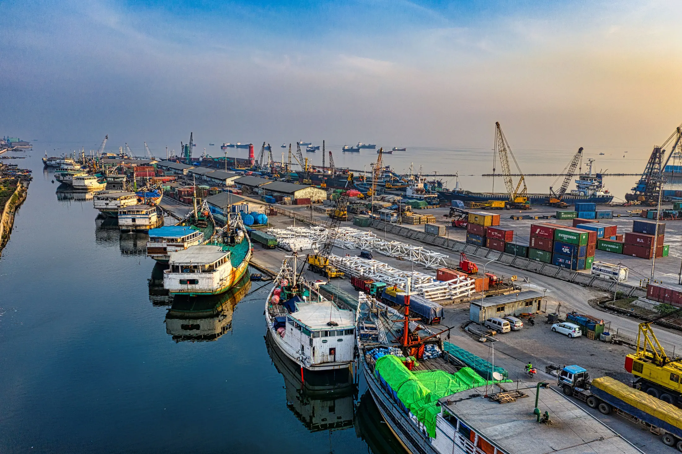 Aerial view of a working port with containers, cranes and vessels