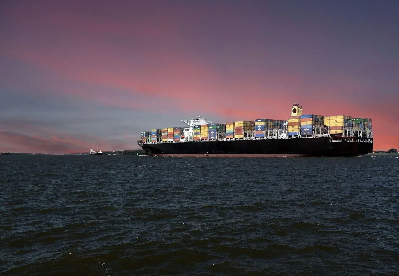 Container ship under way at sunset